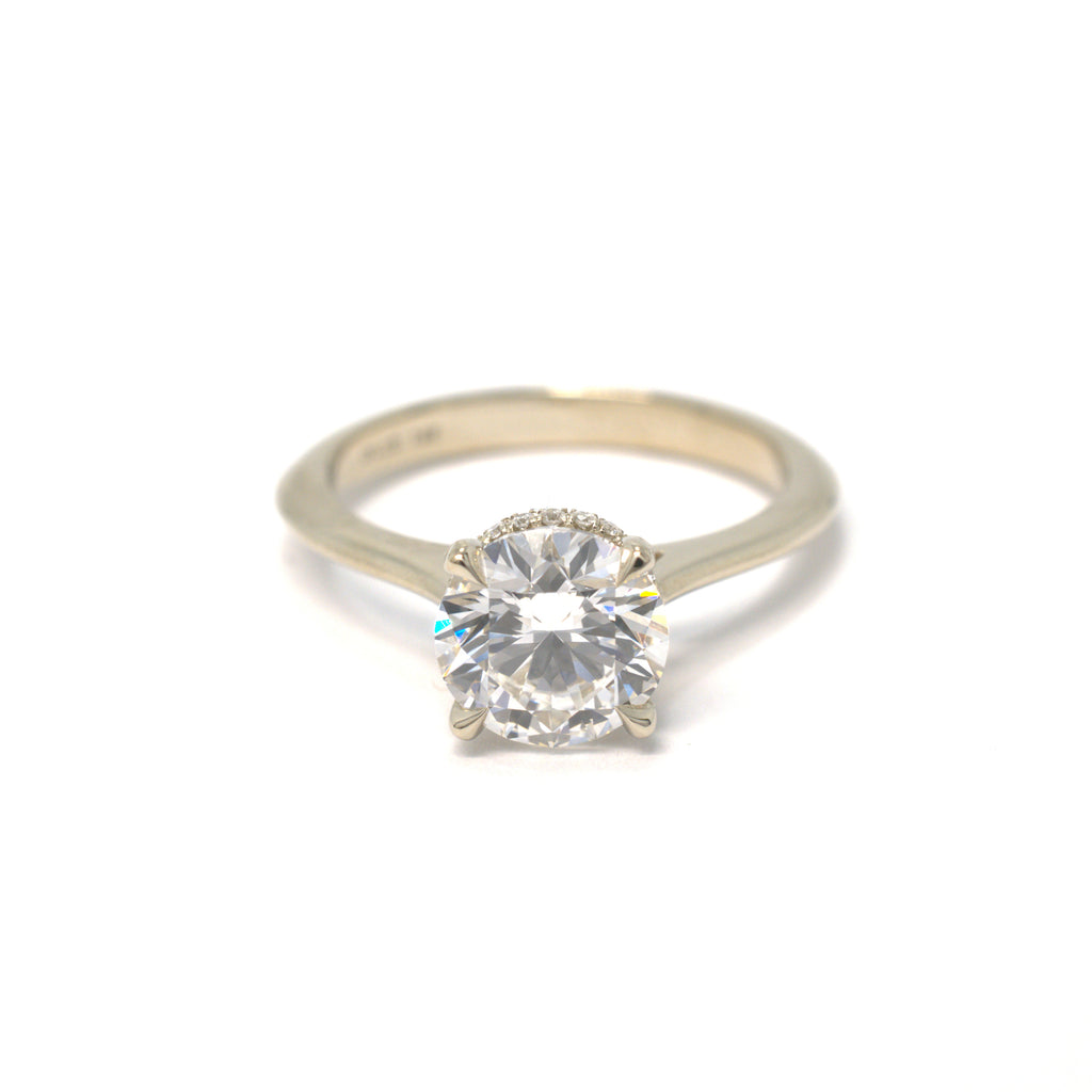 Gold ring with a diamond on a white background